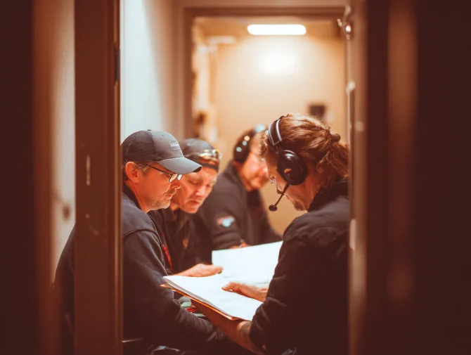 Acoustic specialists reviewing a door's noise performance